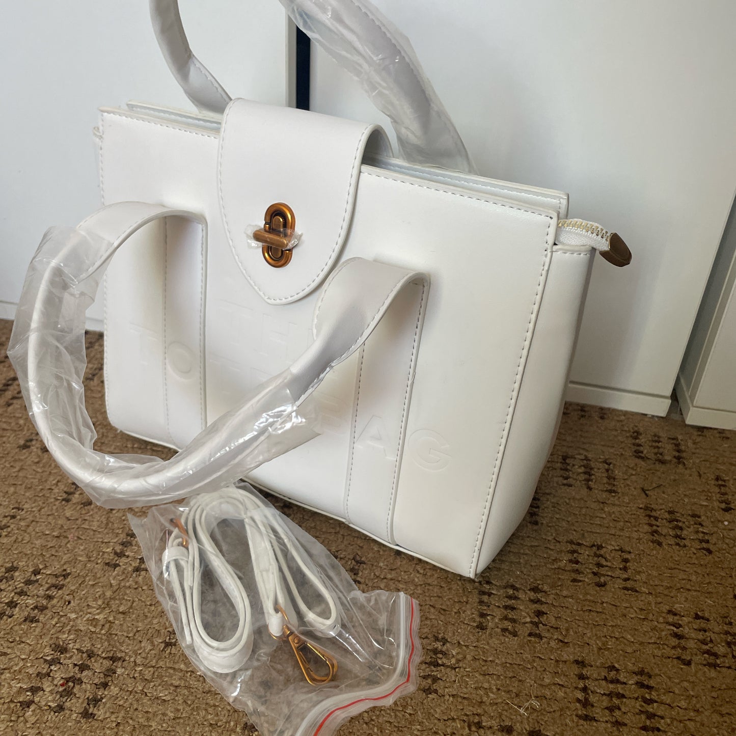 White tote bag with golden hardware