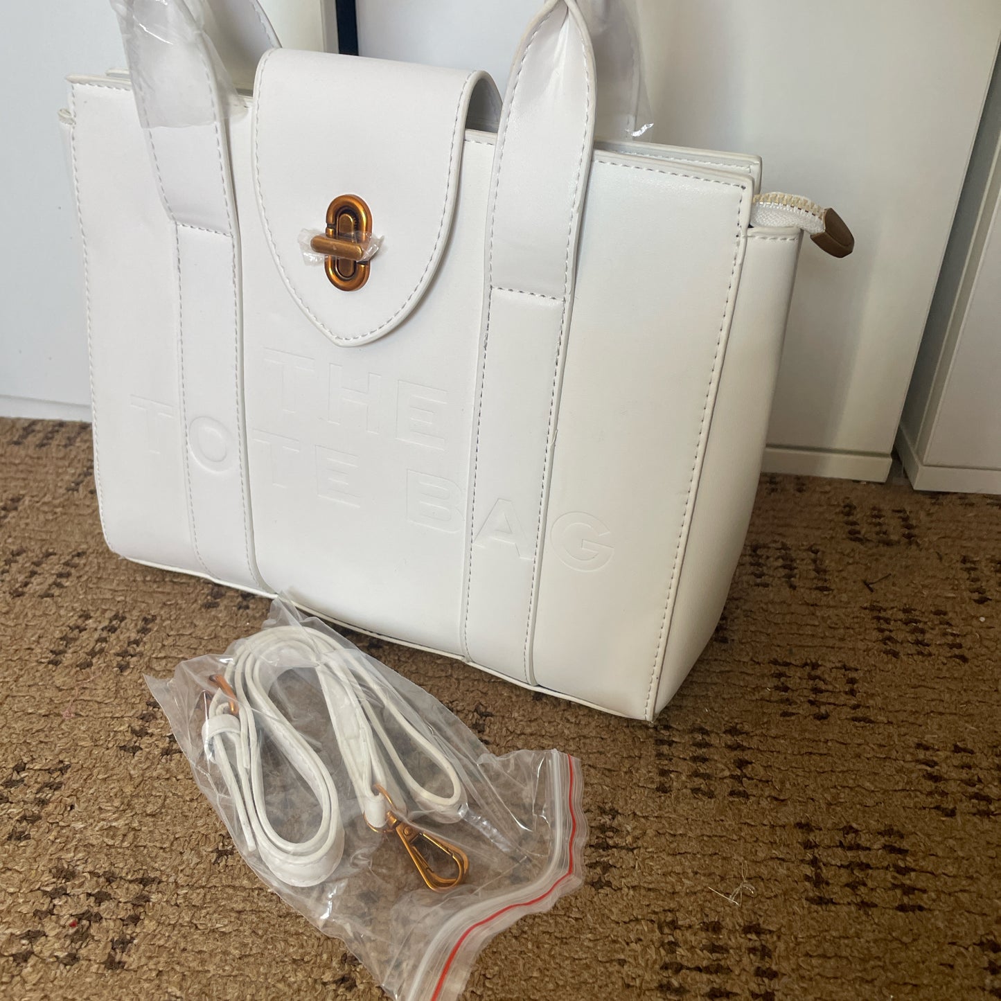 White tote bag with golden hardware